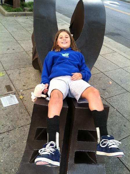 img_2070.jpg - Kayla posing on statue in downtown Santa Cruz