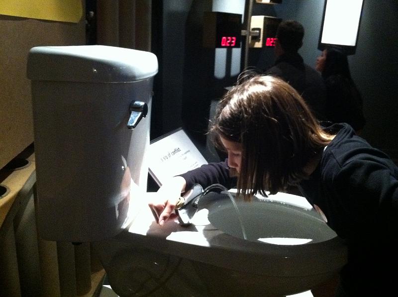 img_1325.jpg - Kayla has no problem drinking out of the toilet at SF Exploratorium