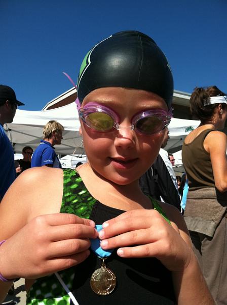 img_1143.jpg - Kinsey earns her first "A" time medal in the 50 Freestyle